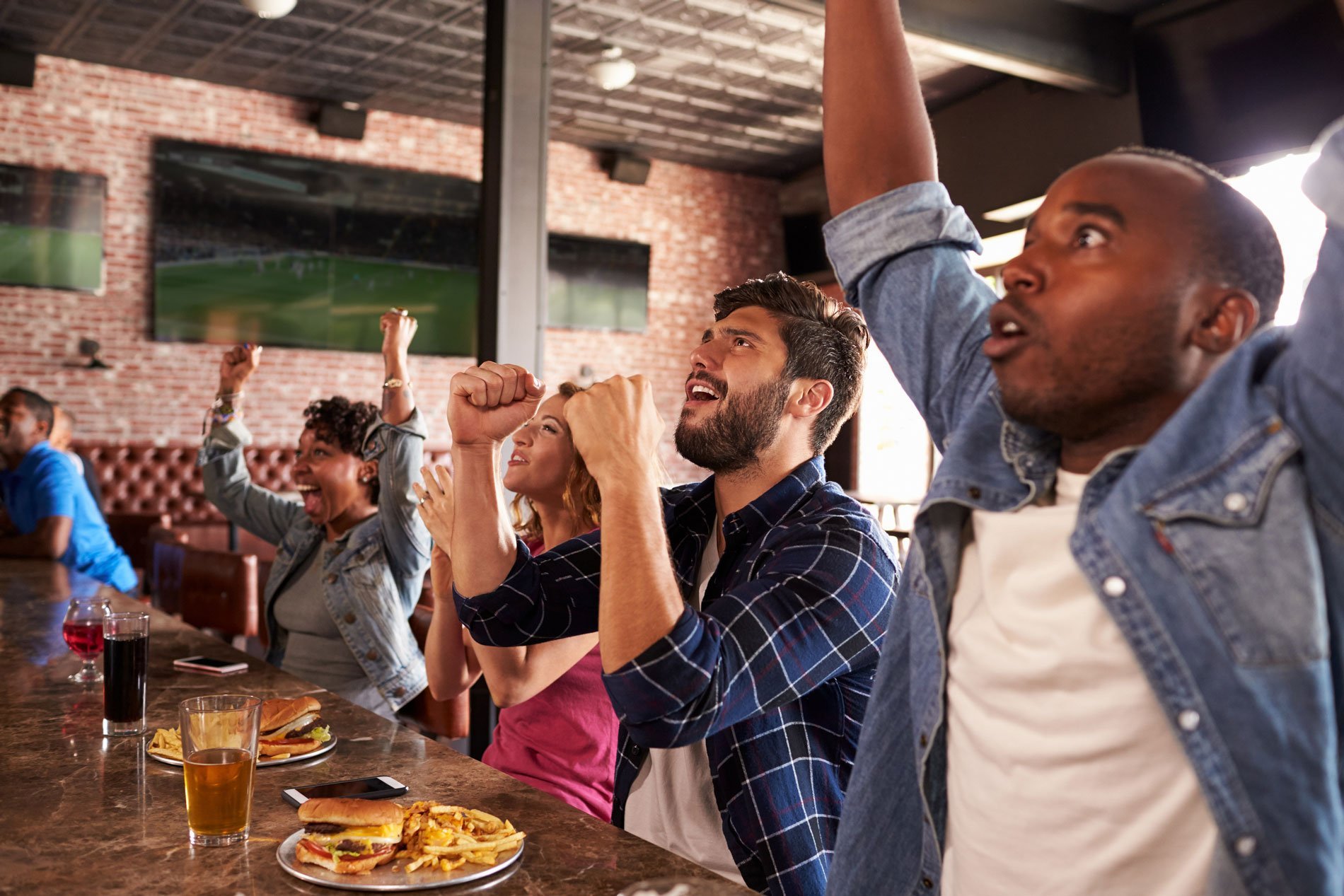 Friends-At-Counter-In-Sports-Bar